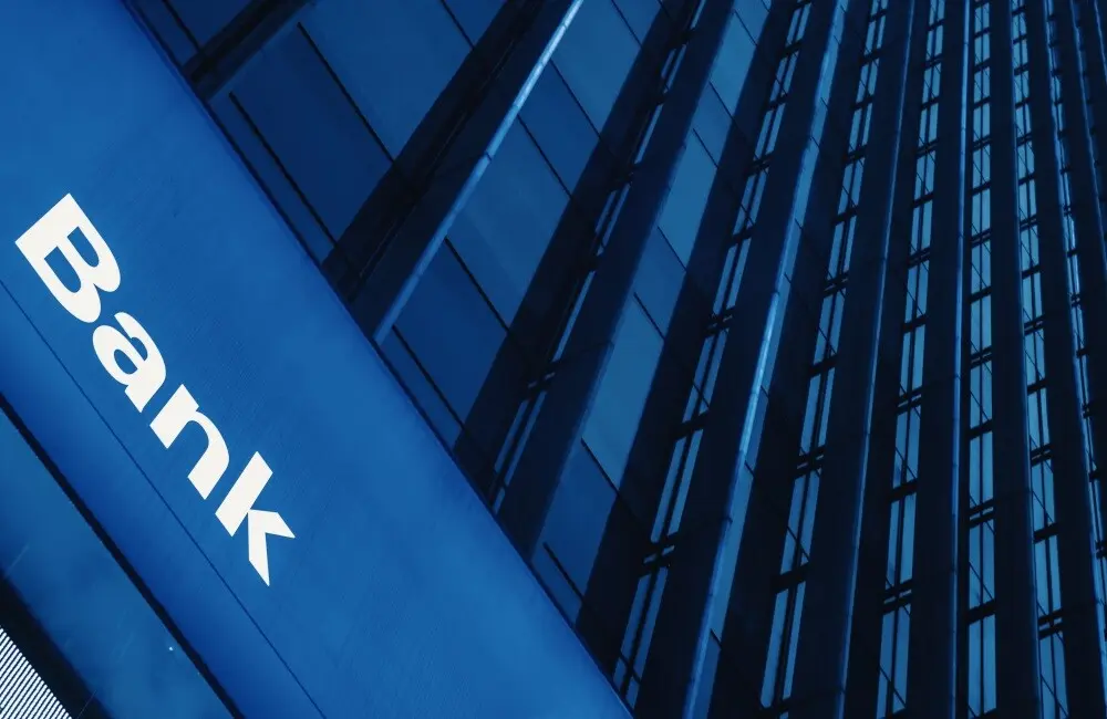 A graphic of a high rise building showing a bank sign on the side of the building.
