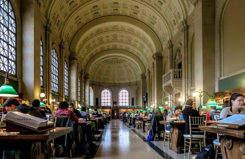 Students study at tables beneath the intricate dome of the library.
