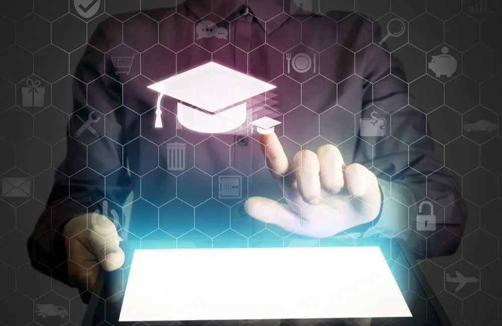 A closeup of hands pointing to a transparent screen and clicking on an icon of a graduation cap.